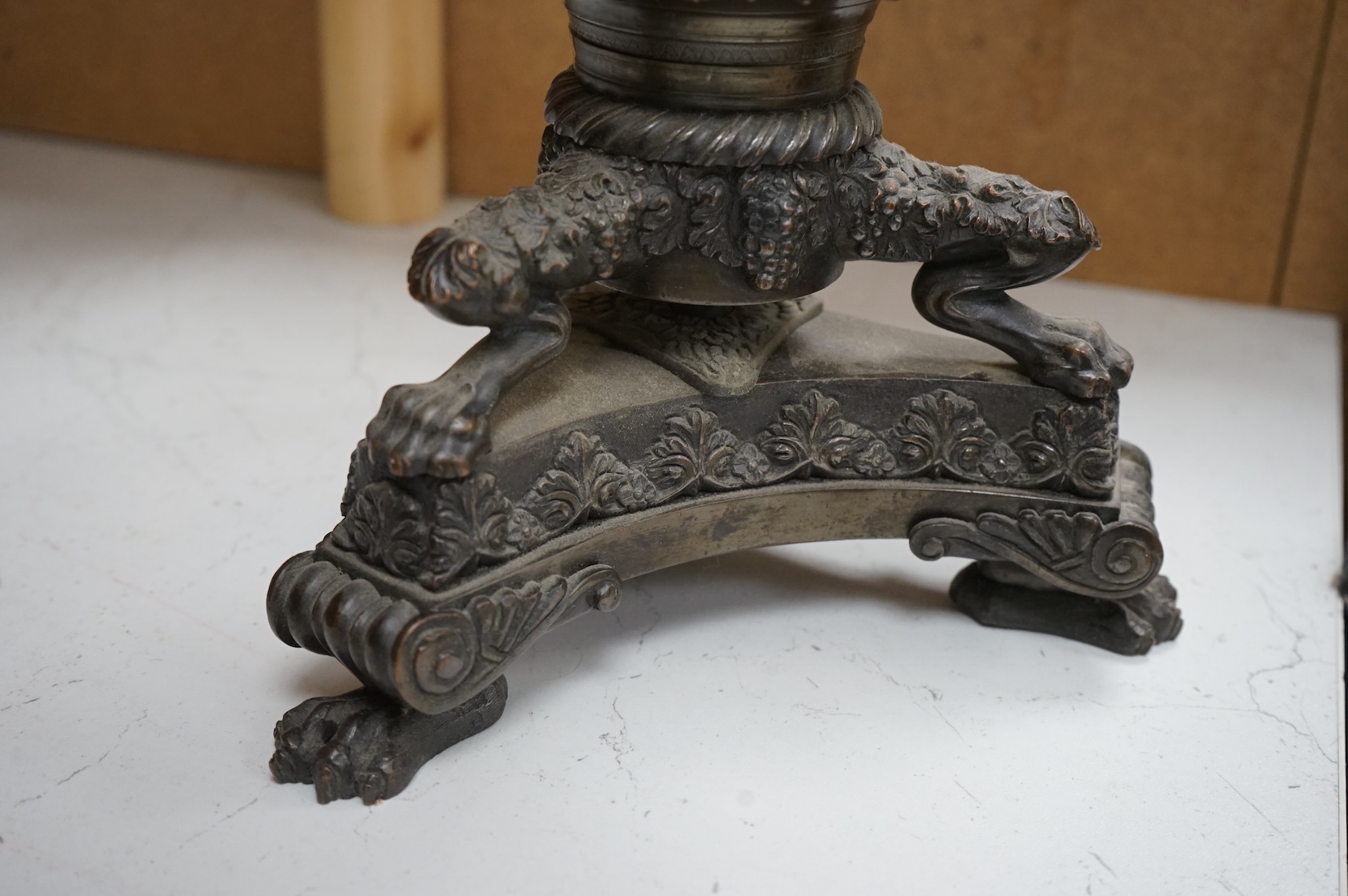 A large cut glass tazza, on bronze tri-form pedestal base, 39cm high.